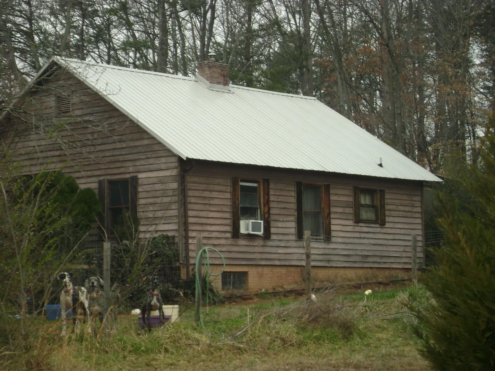 White metal roof on an old wood sided farmhouse, from a Asphalt Shingle Roof Repair job in Mc Donald